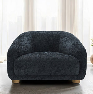 Aaron Contemporary Black Boucle Chair Sloped Arms Dark gray armchair in a room with white curtains