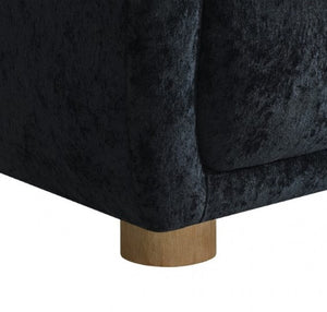 Aaron Contemporary Black Boucle Chair Sloped Arms Close-up of a dark back upholstered chair with a wooden base on a white background