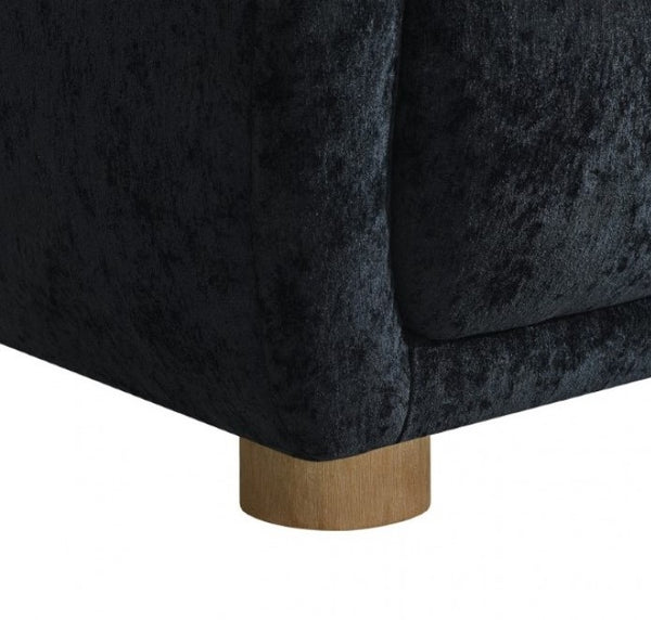 Aaron Contemporary Black Boucle Chair Sloped Arms Close-up of a dark back upholstered chair with a wooden base on a white background
