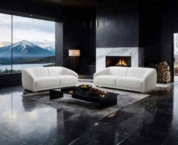 Aaron-Contemporary-White-Boucle-Sofa-Sloped-Arms Modern living room with white sofas, a fire pit, and a fireplace with a mountain view.