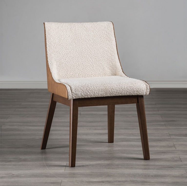Abram Mid Century Modern Walnut Dining Chair A modern dining chair with a cream textured fabric upholstered seat and backrest, supported by a light wood frame and dark brown tapered legs, set against a neutral gray wall and wood-look floor.