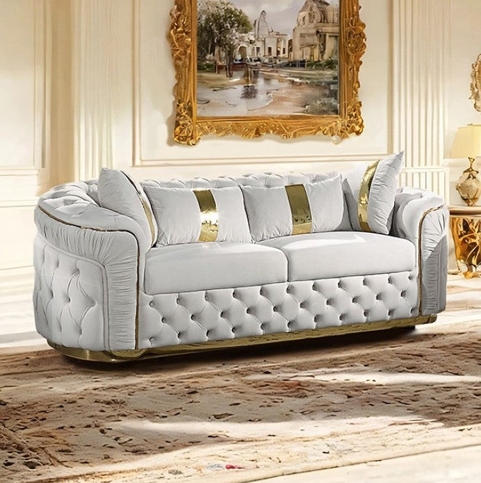 Adriana Glam Beige Sofa Button Diamond Pleated Tufting Luxurious white sofa with gold accents in an elegant room with a large mirror.