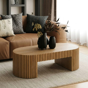 Agata Coffee Table - Natural Ash Finish Modern living room with a wooden coffee table, vases, and a sofa with cushions.