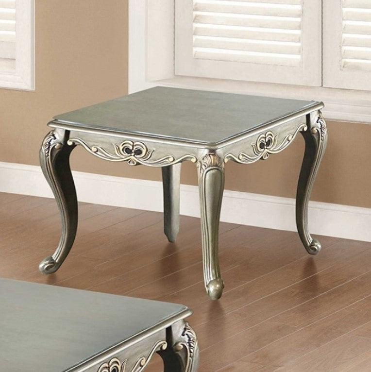 Albert Traditional Champagne End Table Decorative silver table with ornate legs on a wooden floor.