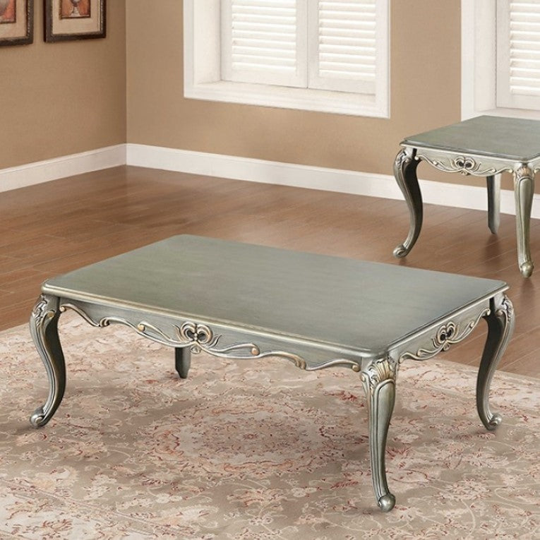 Albert Traditional Champagne Coffee Table Decorative coffee table with ornate legs in a room with beige walls and wooden flooring.