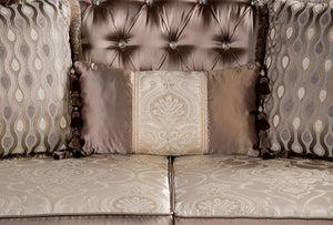 Decorative sofa with patterned cushions and tufted backrest