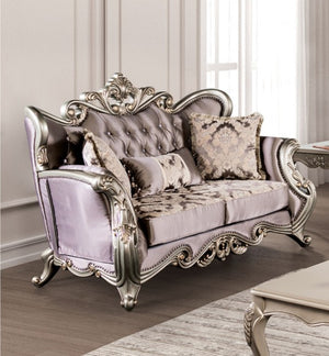 Albert Traditional Velvet Fabric Champagne Purple Loveseat Luxurious silver and gray sofa with ornate designs in a room with light-colored walls and a rug.