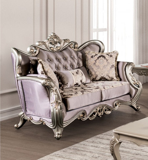 Albert Traditional Velvet Fabric Champagne Purple Loveseat Luxurious silver and gray sofa with ornate designs in a room with light-colored walls and a rug.