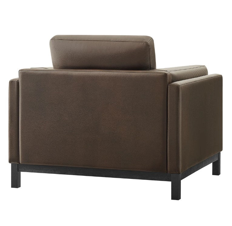 Amadeo Espresso Vegan Leather Modern Chair Brown leather armchair in a living room setting with a window and bookshelf in the background.