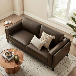 Amadeo Espresso Vegan Leather Modern Sofa Brown leather sofa with decorative pillows in a living room setting.