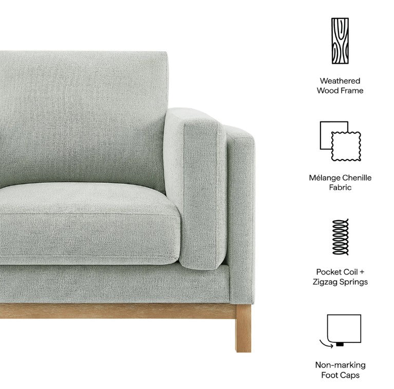 Amadeo Mist Deep Seat Comfort Modern Fabric Chair Gray armchair in a living room with a bookshelf and window in the background