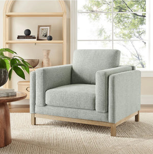 Amadeo Mist Deep Seat Comfort Modern Fabric Chair Gray armchair in a living room with a bookshelf and window in the background
