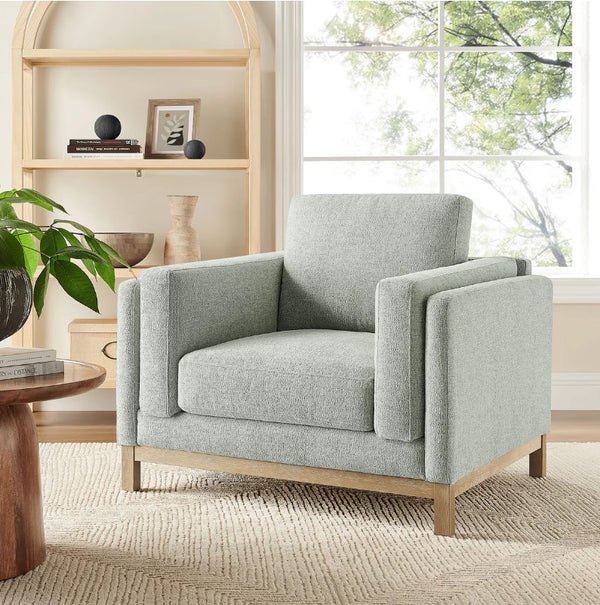 Amadeo Mist Deep Seat Comfort Modern Fabric Chair Gray armchair in a living room with a bookshelf and window in the background