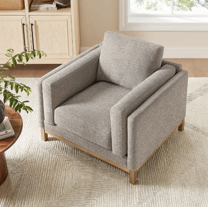 Amadeo Pewter Deep Seat Comfort Modern Fabric Chair Gray armchair in a room with a window and wooden cabinet.