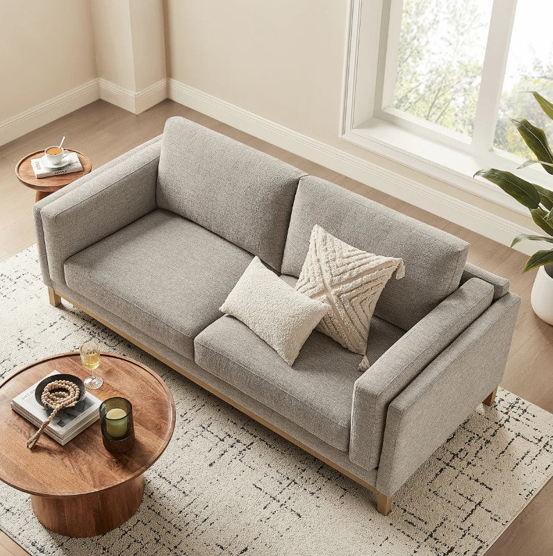 Amadeo Pewter Deep Seat Comfort Modern Fabric Sofa Gray sofa in a living room with a lamp and window in the background