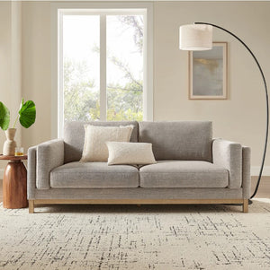Amadeo Pewter Deep Seat Comfort Modern Fabric Sofa Gray sofa in a living room with a lamp and window in the background