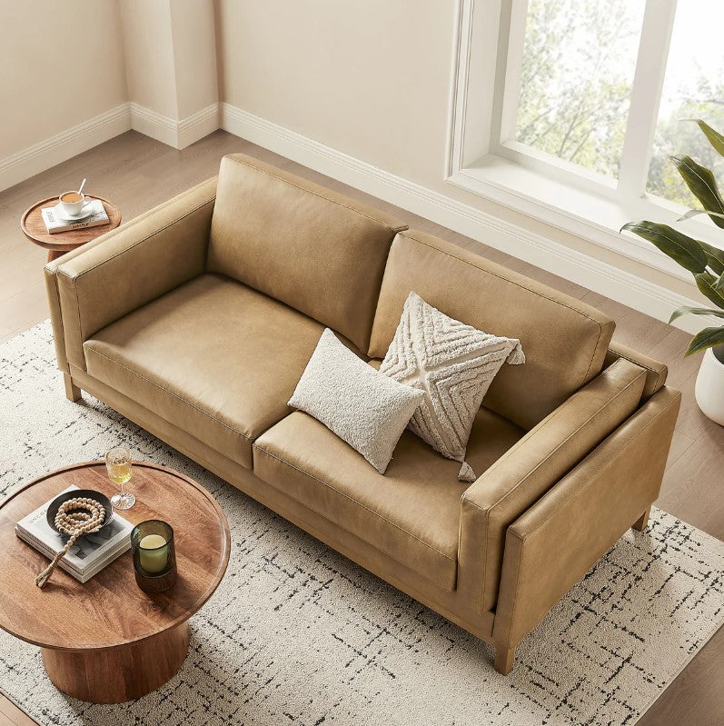 Amadeo Toast Vegan Leather Modern Sofa Beige sofa in a living room with a lamp and window in the background