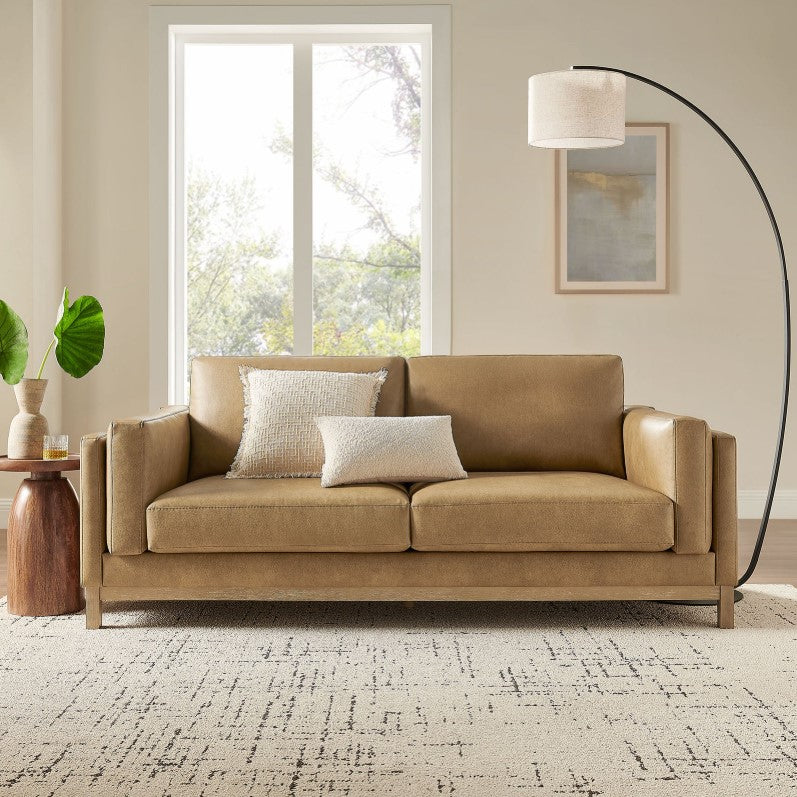 Amadeo Toast Vegan Leather Modern Sofa Beige sofa in a living room with a lamp and window in the background