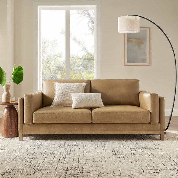 Amadeo Toast Vegan Leather Modern Sofa Beige sofa in a living room with a lamp and window in the background