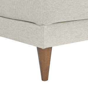 Close-up of a light gray upholstered chair with wooden leg on a white background
