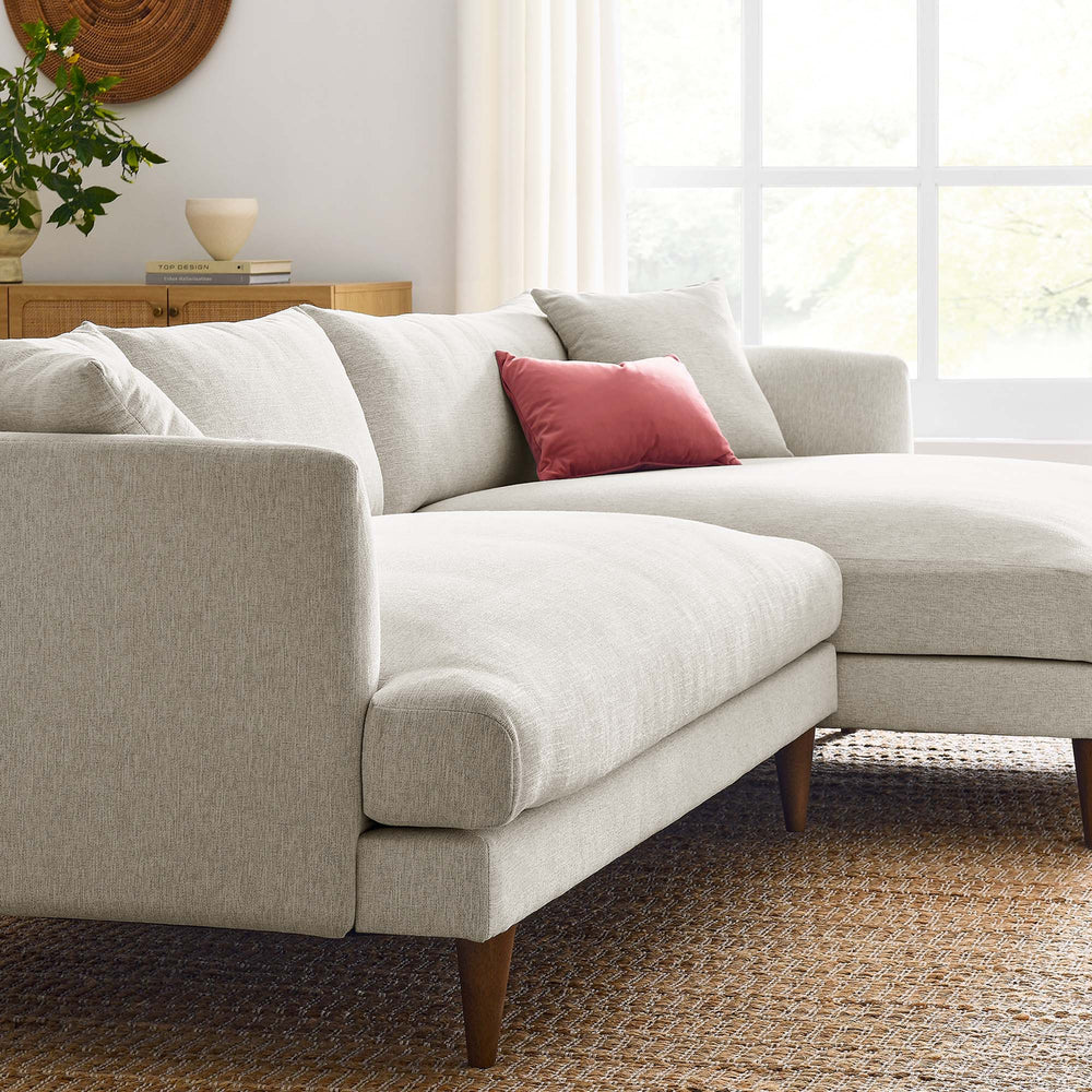 Modern living room with a IVORY sectional sofa, wooden coffee table, and decorative elements.