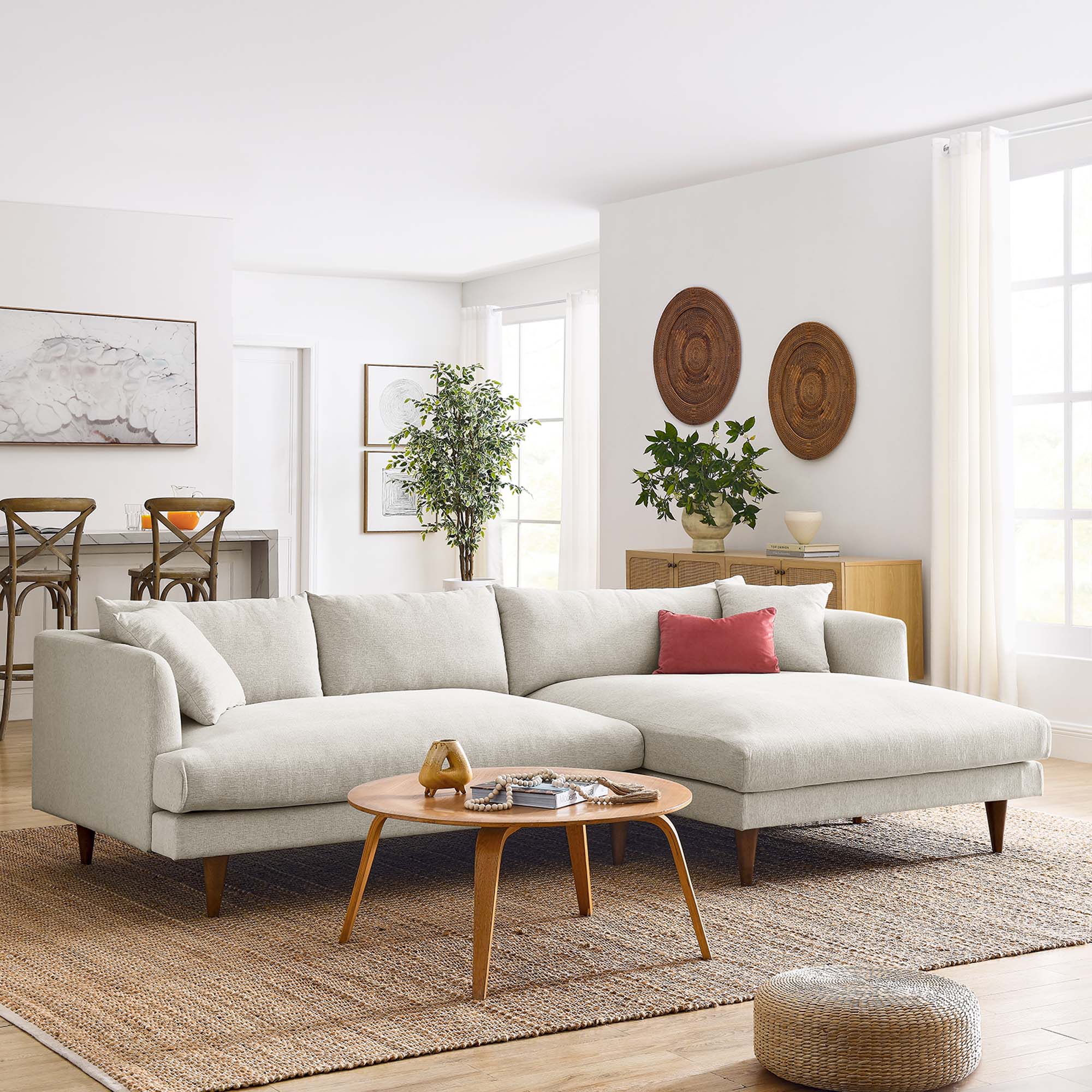 Modern living room with a IVORY sectional sofa, wooden coffee table, and decorative elements.