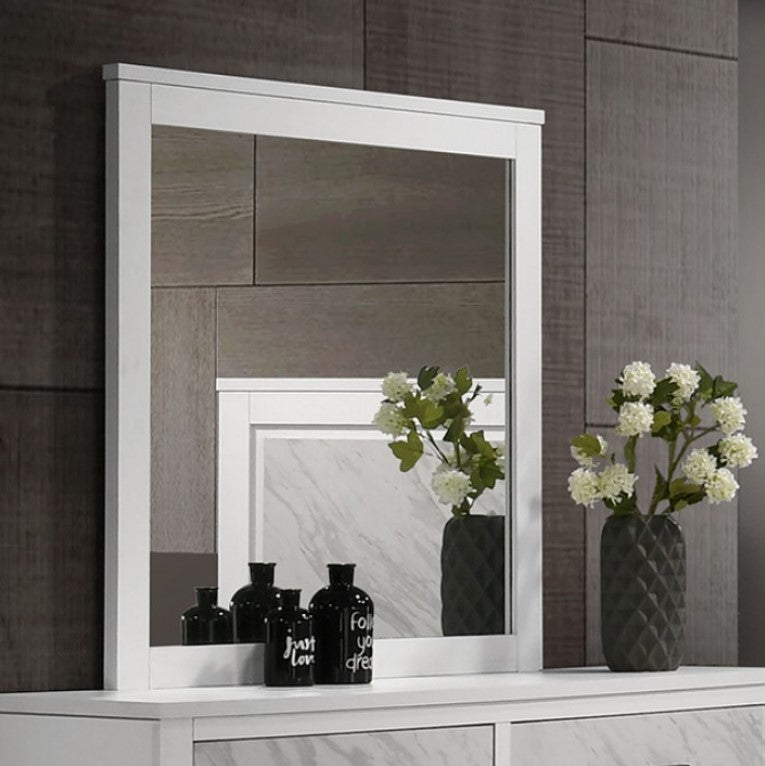 White framed mirror on a wooden wall with decorative vases and flowers.