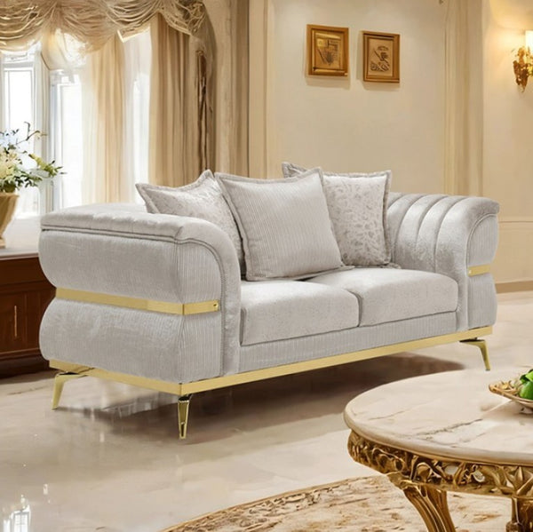 Ari Glam Beige Loveseat Flare Channeled Arms Gold Accents Gray sofa with gold accents in a luxurious living room setting