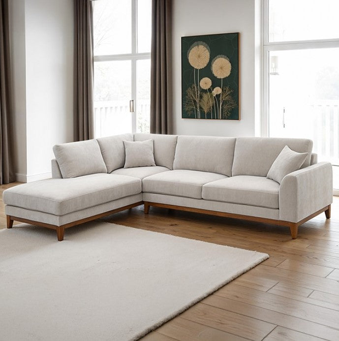 Arieal Mid-Century Modern Chenille Fabric Sectional Light gray sectional sofa in a living room with large windows and a rug.