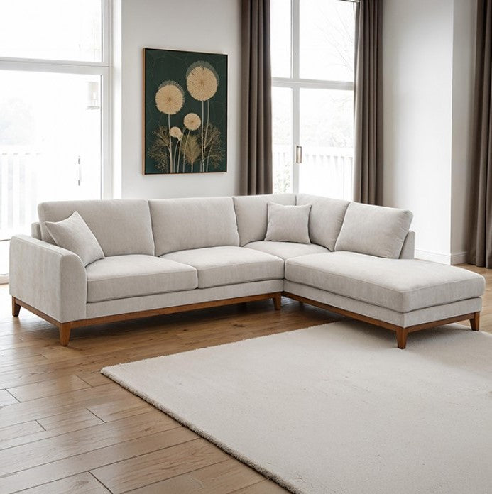 Arieal Mid-Century Modern Chenille Fabric Sectional Light gray sectional sofa in a living room with large windows and a rug.