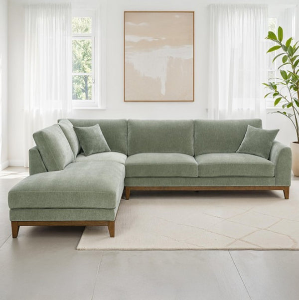 GArieal Mid-Century Modern Olive Green Chenille Fabric Sectional sectional sofa in a bright living room with a plant and artwork.