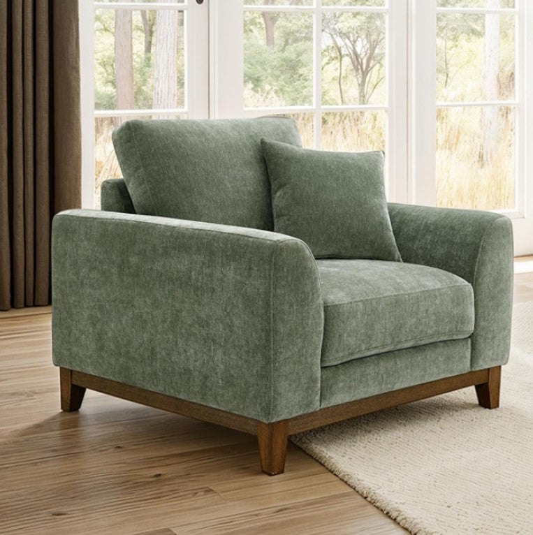 Arieal Mid-Century Modern Olive Green Chenille Fabric Chair Green armchair in a room with large windows and wooden flooring.