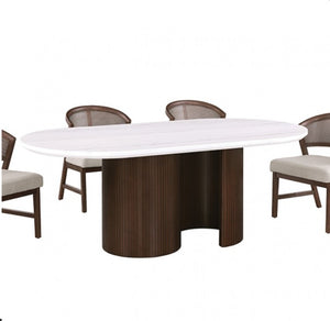 Artemos Contemporary White Oval Dining Table An oval dining table with a white marble-look top and a dark brown fluted pedestal base, shown with four matching chairs on a plain white background.