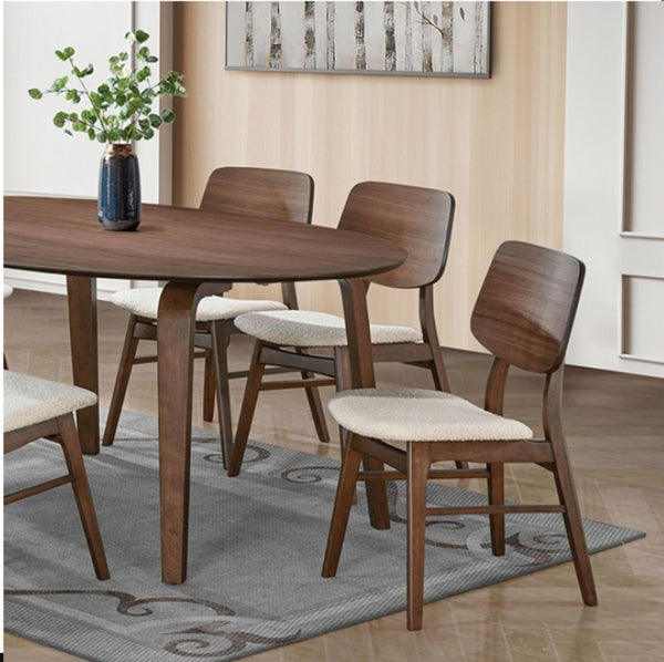Artemos Mid Century Walnut Oval Dining Table A 5-piece dining set featuring a round wooden table and four matching chairs with cream upholstered seats, styled in a modern dining room setting.