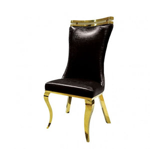 Asher Silver Black Leatherette Dining Chair 2-Pack A luxury dining chair featuring a tall, curved backrest upholstered in black textured leather, supported by a polished gold-finished metal frame with curved legs and a matching gold top rail.