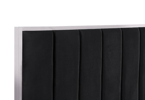 Ashysko Black Silver Fully Upholstered Bed Close-up of a black upholstered headboard with vertical channel tufting and a light wood or beige side frame, shown against a plain white background.