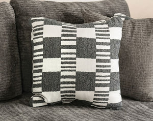 Assia L-Shape Sectional Sofa Checkered pillow on a gray sofa