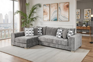Assia L-Shape Sectional Sofa Gray sectional sofa in a living room with decorative pillows and wall art.