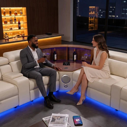 Aurelia Beige Modern Air Leather Sectional Sofa Powered Recliner A man in a gray suit and a woman in a beige dress sit across from each other on a cream sectional sofa in a modern lounge room with blue LED underlighting, wine bottles, and a city view at night.