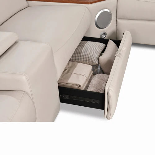 Aurelia Beige Modern Air Leather Sectional Sofa Powered Recliner A close-up of a beige leather reclining sofa with a storage compartment pulled open, showing folded bedding and pillows inside.