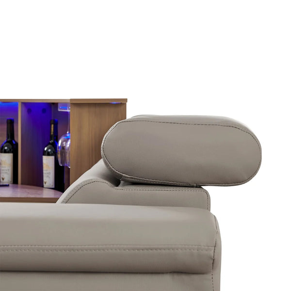 Aurelia Modern 5 Seat Sectional Sofa Powered Recliner Close-up of a light beige upholstered chair or recliner with a rounded headrest, shown against a white background with a wooden shelf and wine bottles partially visible on the left.