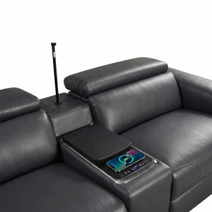Aurelia Modern Air Leather Sectional Sofa Powered Recliner Black leather reclining sofa with a center armrest console, a vertical cup holder with a black handle, and a tablet charging tray holding a smartphone.
