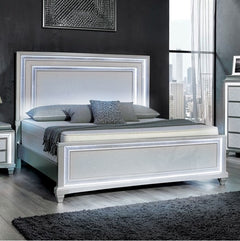 Aurielle gray bed in a modern bedroom with large windows and cityscape view.