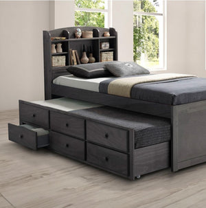 Ava Transitional Style Solid Wood Bookcase Trundle Storage Youth Bed Gray bed with storage drawers and bookshelf headboard in a room with windows.