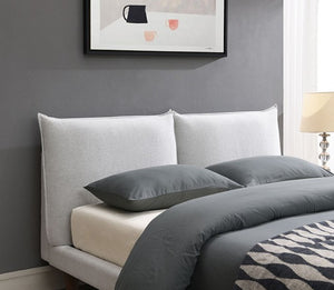 Bassetti Modern Style Shelter Padded White Bed Gray bedding on a bed with a gray wall and abstract art above.