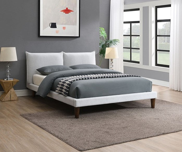 Bassetti Modern Style Shelter Padded White Bed Bedroom with a bed featuring gray bedding and a white headboard, a lamp, and a plant.