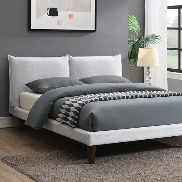 Bassetti Modern Style Shelter Padded White Bed Bedroom with a bed featuring gray bedding and a white headboard, a lamp, and a plant.