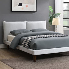 Bassetti Modern Style Shelter Padded White Bed Bedroom with a bed featuring gray bedding and a white headboard, a lamp, and a plant.