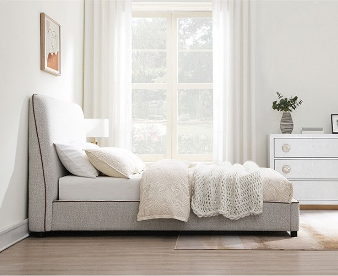 Bella Fully Upholstered Polyester Bed Neatly made bed with beige bedding in a bedroom setting