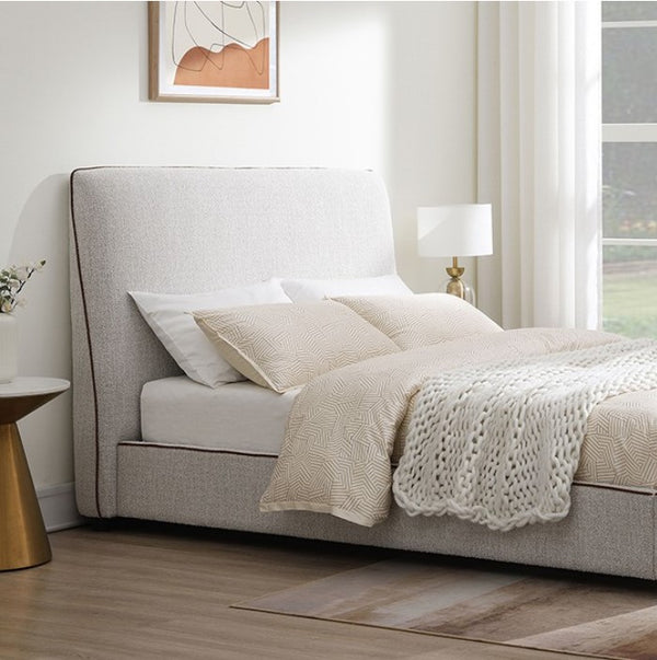 Bella Fully Upholstered Polyester Bed Neatly made bed with beige bedding in a bedroom setting